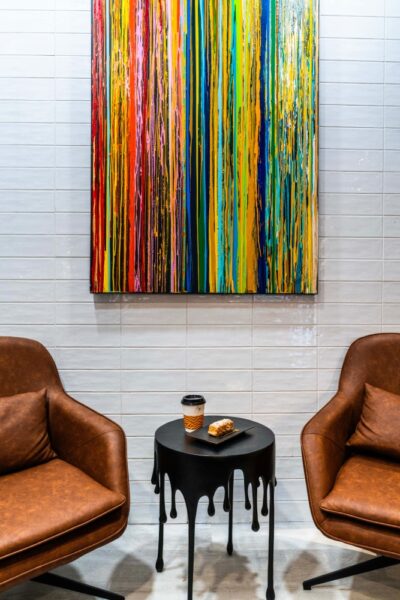 goldstruck leather armchairs table painting